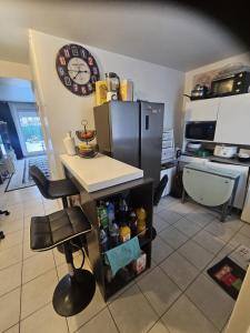 a kitchen with a counter and a refrigerator at Chez Ismael in Melun