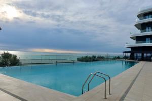 a swimming pool on top of a building at Ilyonis Residence apartment luxury in Shëngjin