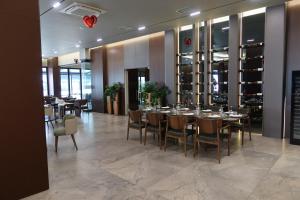 a restaurant with tables and chairs and wine racks at Ilyonis Residence apartment luxury in Shëngjin