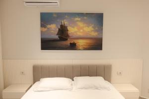 a painting of a ship in the ocean at Ilyonis Residence apartment luxury in Shëngjin