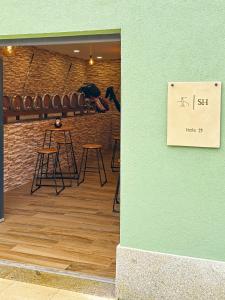 a room with stools and a sign that reads hide dj at Sandoco - Golf - Pickleball - Beach Volleyball & Pool - All Exclusive in Ponte de Lima