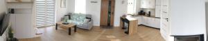 a kitchen with a couch and a table in a room at Domek Na Klinie in Jastrzębia
