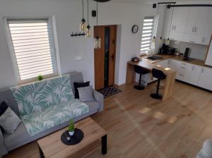 a living room with a couch and a table at Domek Na Klinie in Jastrzębia