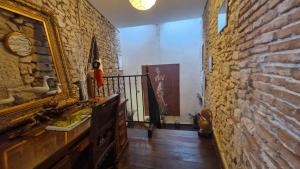 a hallway with a brick wall and a stair case at Le Nid des Oiseaux in Cubjac +163 photos