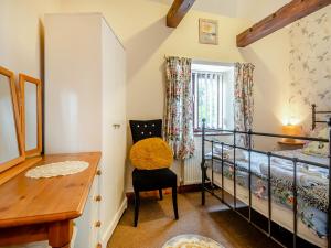a small room with a desk and a chair at Pear Tree Cottage in Banham +13 photos
