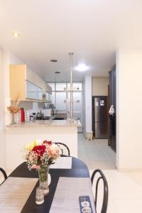 a kitchen with a table with a vase of flowers on it at Casa completa, 5 dormitorios y jardín in Ayacucho