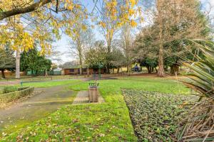 a park with a bench in the grass at Flat 8- Garden Square in Banbury