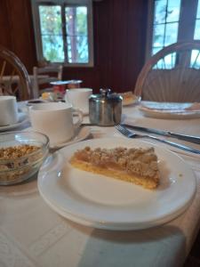 a piece of pie on a white plate on a table at Hostal Los Riscos in Llanquihue