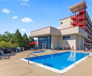 a building with a swimming pool in front of a building at New 2 Bed 2 Bath Condo with Pool at BMS in Bristol