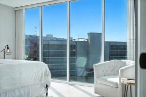 a bedroom with a bed and a chair and a large window at New 2 Bed 2 Bath Condo with Pool at BMS in Bristol +29 photos