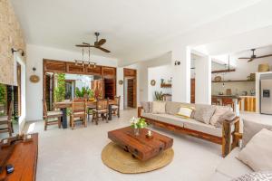 a living room with a couch and a table at Coconut Villas Zanzibar in Matemwe