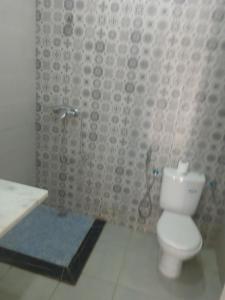 a bathroom with a toilet and a sink and a shower at Suite in nice résidence in Rabat