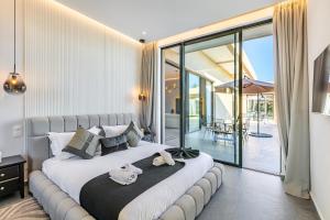 a bedroom with a large bed with two towels on it at Villa Prestige Privée avec Vue Splendide in Marrakesh +18 photos