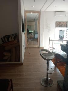 a living room with a stool in the middle of a room at Suite in nice résidence in Rabat +3 photos