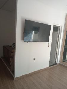 a white wall with a flat screen tv on a wall at Suite in nice résidence in Rabat