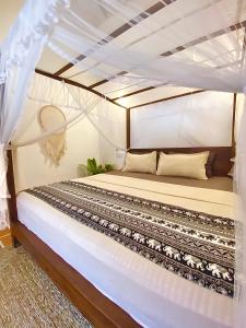 a bedroom with a bed with a canopy at MAYA Ahangama in Ahangama