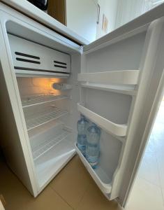 an open refrigerator with bottles of water in it at Apartament Mare e Sole z basenem i przy plaży in Marotta