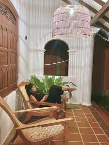 a woman laying in a chair on a patio at MAYA Ahangama in Ahangama +13 photos