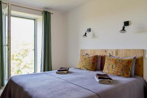 a bedroom with a large bed with a window at Maison Chalendeix in Nedde