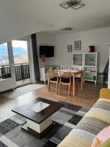a living room with a table and a dining room at Ferienhaus Schiemel in Altmünster