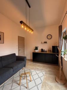a living room with a couch and a table at Entre sabots et ronrons in Butten