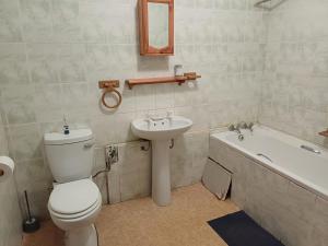 a bathroom with a toilet and a sink and a bath tub at Gouritsmond Self Catering Units in Gouritzmond