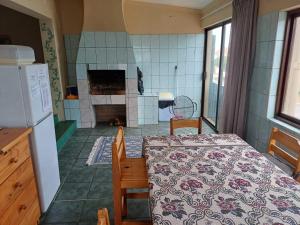 a kitchen with a table and a kitchen with a fireplace at Gouritsmond Self Catering Units in Gouritzmond