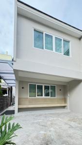 a large white house with windows on it at Little Escape in Bangkok