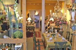 a store with tables and chairs and people in a room at Hotel am Glockenturm in Lüchow
