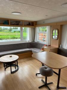 a living room with a couch and a table at Houseboatvinkeveen Lelie in Vinkeveen