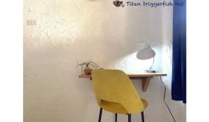 a yellow chair sitting in front of a desk at Triggerfish Hut at Casa Domingo in Ban Thong Phlu