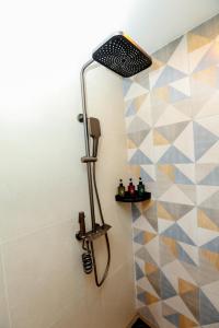 a shower in a bathroom with a shower head at Sun Top Grand in Ella +36 photos