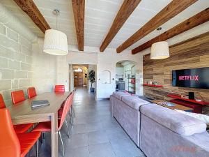 a living room with a couch and a table at Mia - Your Gozo Haven with Pool in Xagħra