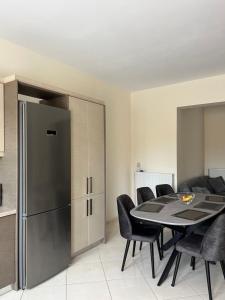 a dining room with a table and a refrigerator at Amare suite 2 in Perivólia