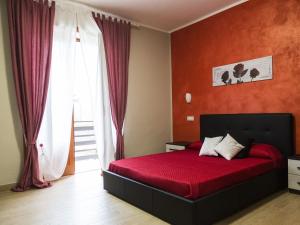 a bedroom with a red bed and a window at Villa Filomena Resort in Serino