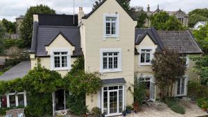 a house with white windows and ivy at Bedford Lodge in Shanklin