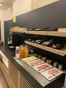 a buffet line with plates of food and drinks at Hotel Cleo in Kasterlee +8 photos