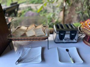 a table with two baskets of bread and a toaster at มาดูดอย - Madoodoi in Ban Mae Na