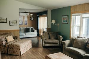 a living room with a couch and a chair and a table at Outbounder in Bayfield