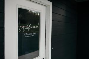 a window with a welcome sign on the side of a house at Outbounder in Bayfield