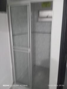ein gläserner Kühlschrank mit offener Tür in einer Küche in der Unterkunft Hotel eden centro in Medellín