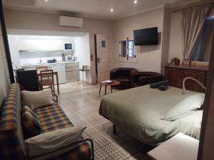a hotel room with a bed and a living room at Suite Duquesa de Parcent in Ronda