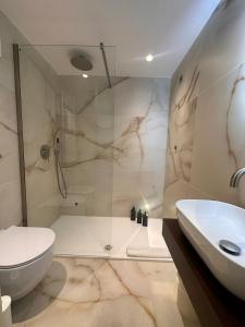a bathroom with a shower and a toilet and a sink at Hotel Europa in Taranto +111 photos