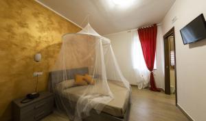 a bedroom with a bed with a mosquito net at Villa Filomena Resort in Serino