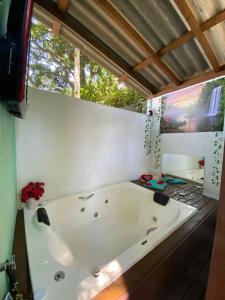 a large white tub in a room with a window at Residencial Rodrigues Florianópolis in Florianópolis +63 photos