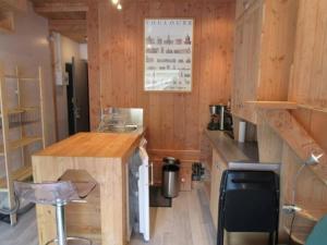 a kitchen with wooden walls and a wooden counter top at Studette cosy 2 pers centre station La Mongie - FR-1-404-120 in La Mongie