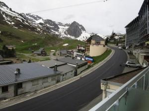a winding road in a small town with a mountain at Studette cosy 2 pers centre station La Mongie - FR-1-404-120 in La Mongie +4 photos