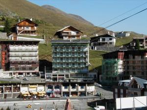 a group of buildings with mountains in the background at Studette cosy 2 pers centre station La Mongie - FR-1-404-120 in La Mongie