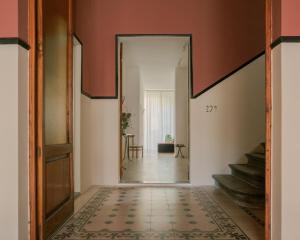 a hallway with a door leading to a room with stairs at Palazzina Maresa in Florence +96 photos