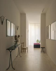 a large white room with a table and a chair at Palazzina Maresa in Florence